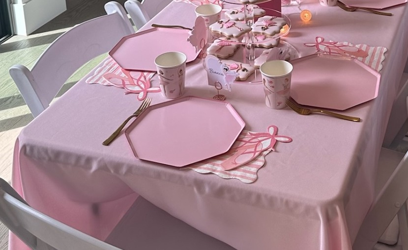 Pink place setting with octagonal plate, gold cutlery and ballet slipper napkin detail
